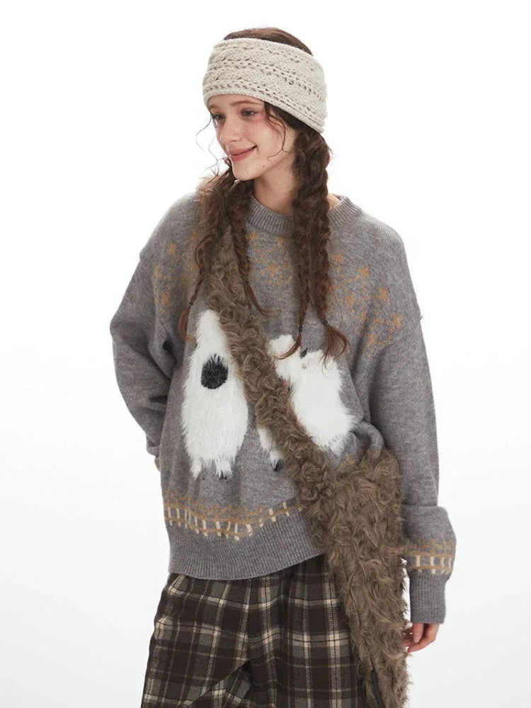 Close-up of a woman wearing a grey knit sweater with a graphic sheep print, accessorized with a faux fur bag.