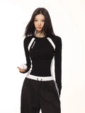 Model wearing a black and white long-sleeve athletic top, holding a baseball.