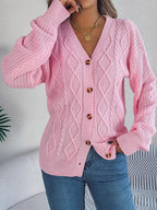 Woman adjusting her pink cable knit cardigan