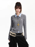 Woman wearing a grey cable knit cardigan with a blue collared shirt and a gold cross pendant.