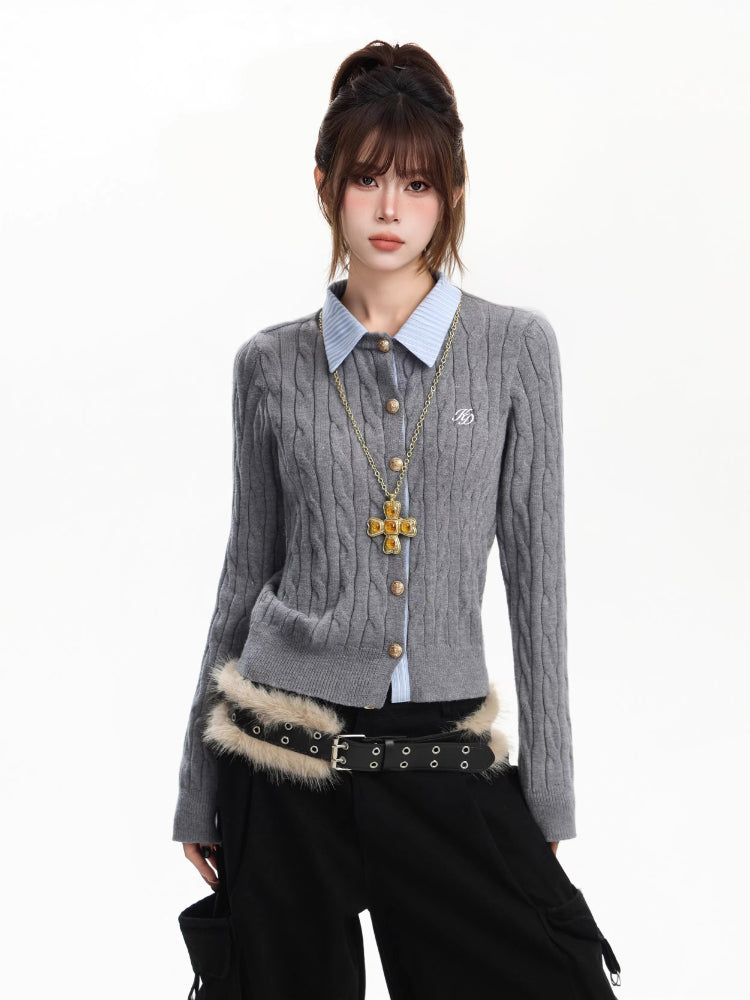 Woman wearing a grey cable knit cardigan with a blue collared shirt and a gold cross pendant.
