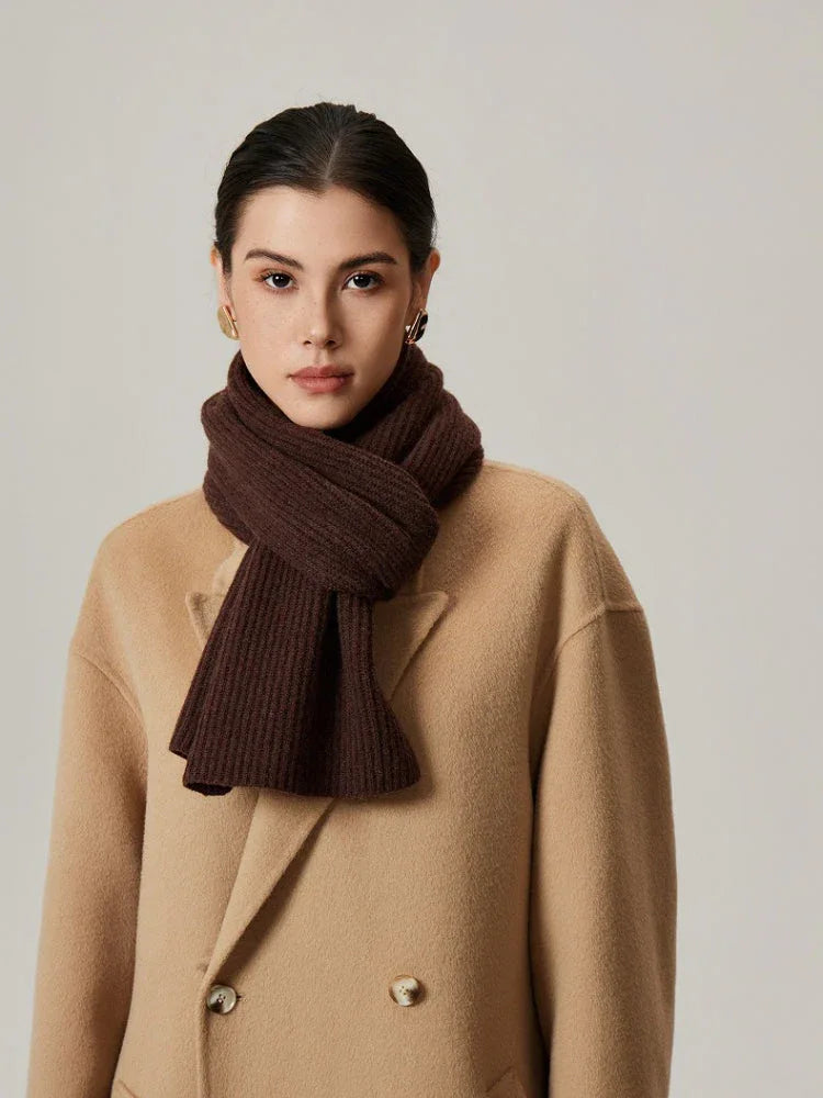 Close-up of a dark brown ribbed knit scarf around a woman's neck