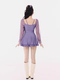Rear view of the purple long-sleeve swim dress with ruffled hem
