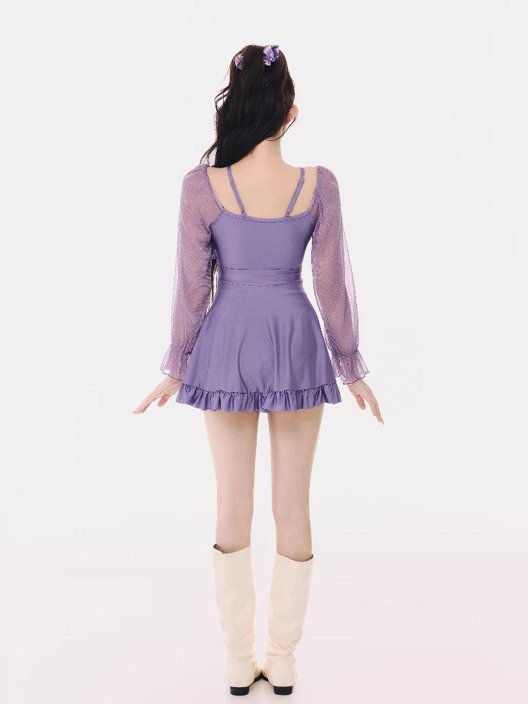 Rear view of the purple long-sleeve swim dress with ruffled hem