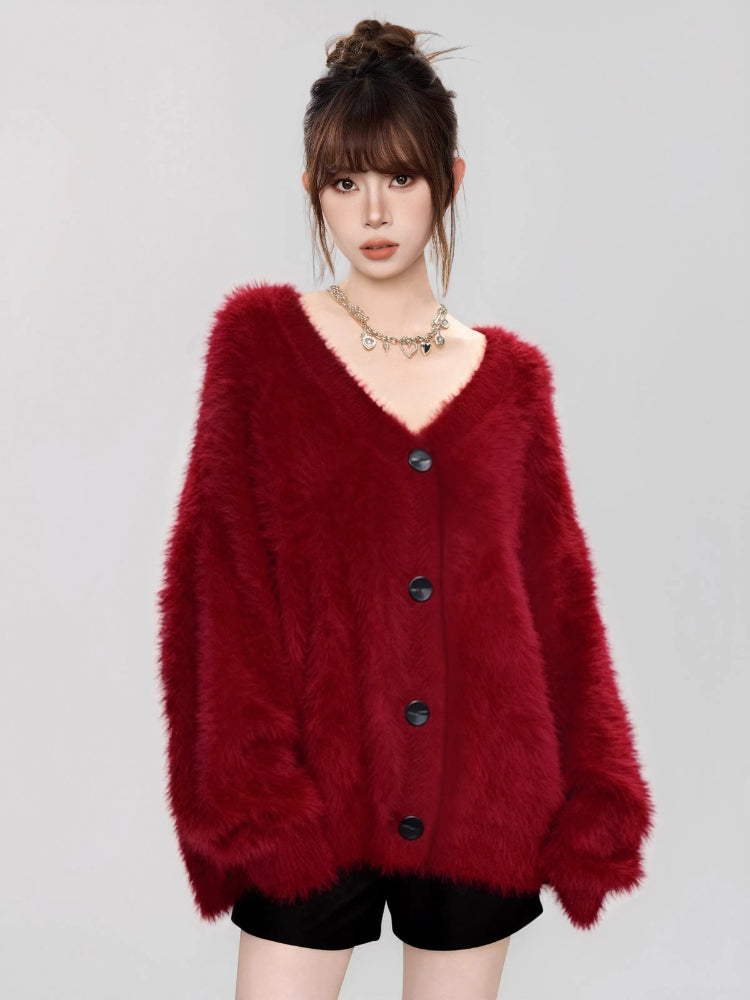 Close-up of the texture of a red fluffy knit cardigan.