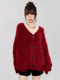 Close-up of the texture of a red fluffy knit cardigan.