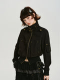 Full body shot of a woman in a black cropped bomber jacket, styled with layered skirts and wide-leg pants.