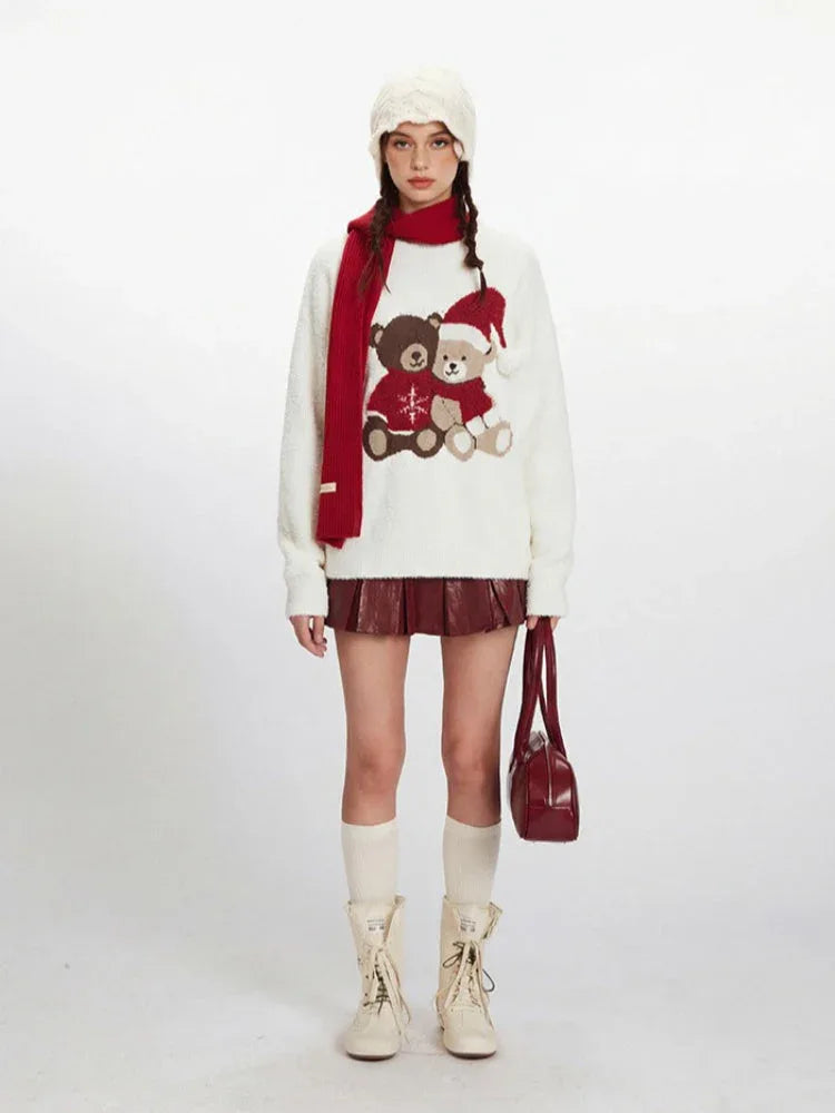 Woman wearing a white fuzzy knit sweater with a teddy bear graphic and red scarf