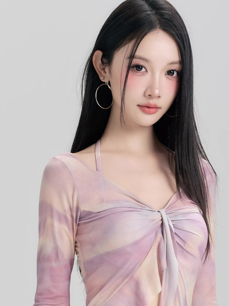 Close-up of the v-neck and tie-front detail on a lavender and peach tie-dye mesh long sleeve mini dress