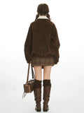 Back view of a woman in a brown corduroy bomber jacket.