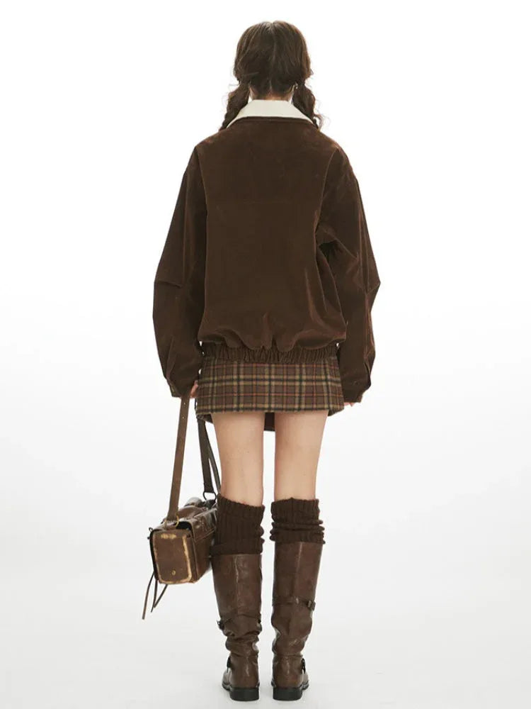 Back view of a woman in a brown corduroy bomber jacket.