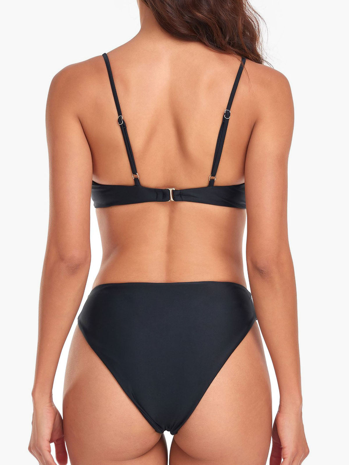 Back view of a woman wearing a black bikini with adjustable straps and a clasp closure