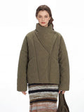 Front detail of an olive green quilted jacket with an asymmetrical closure and a gold-tone clasp.