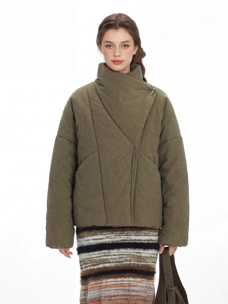 Front detail of an olive green quilted jacket with an asymmetrical closure and a gold-tone clasp.
