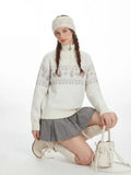 Detail shot of the ribbed cuffs and hem on a Fair Isle knit sweater.