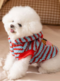 Dog wearing a blue and red striped hooded dog coat, showing the front and side.