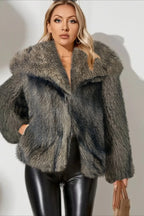 Woman wearing a grey faux fur jacket with a wide collar and leather pants.