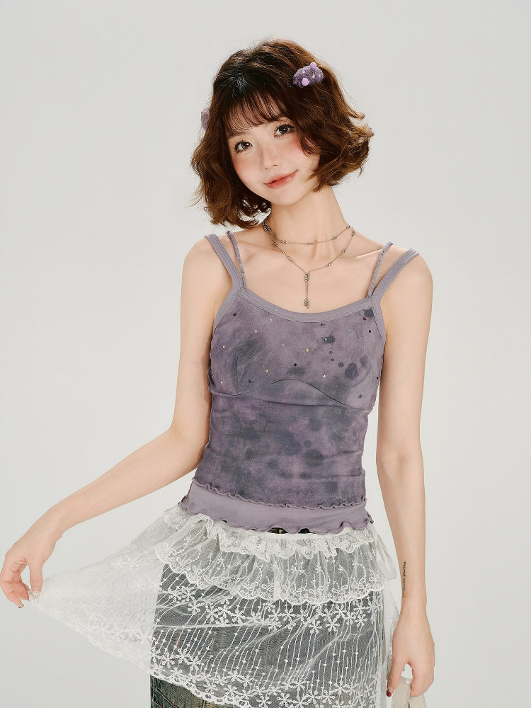 Woman wearing a purple tie-dye camisole with sequin details and a ruffled hem