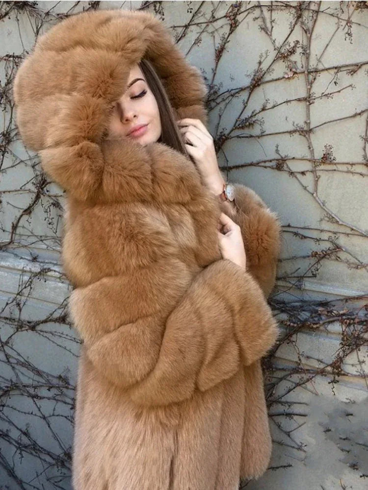 Woman wearing a tan hooded faux fur coat, with eyes closed.