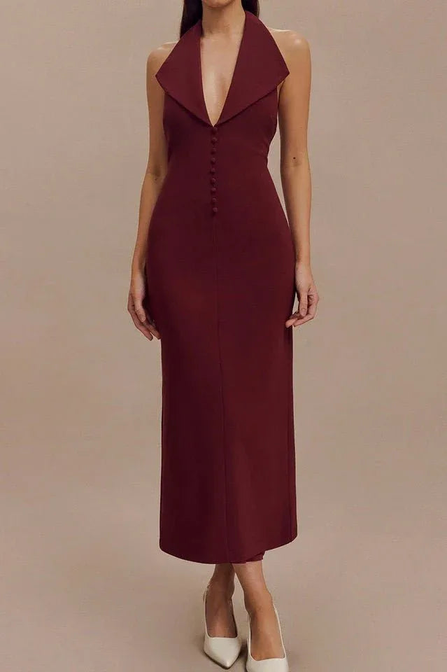 Woman wearing a burgundy sleeveless midi sheath dress with a deep V-neck, sharp collar, and button front detail. Main image