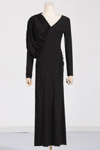A mannequin wearing a black ruched V-neck dress with long sleeves.