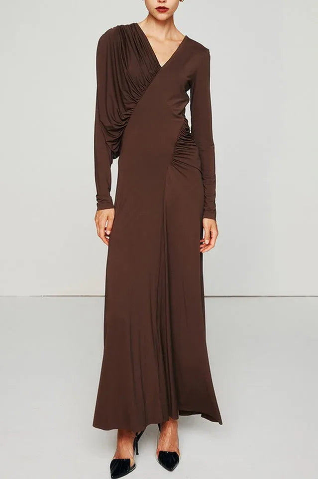 Woman wearing a long brown ruched V-neck dress with long sleeves. Main image