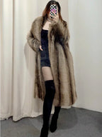 Woman wearing a long brown faux fur coat.
