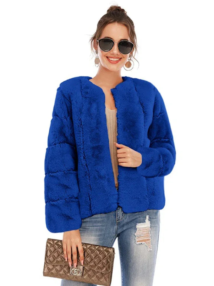 Woman wearing a royal blue faux fur jacket with an open front and textured sleeves.