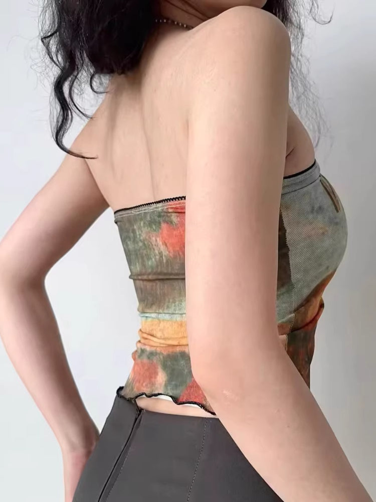 Woman wearing a graphic print strapless tube top with 'Wild West' text and imagery.