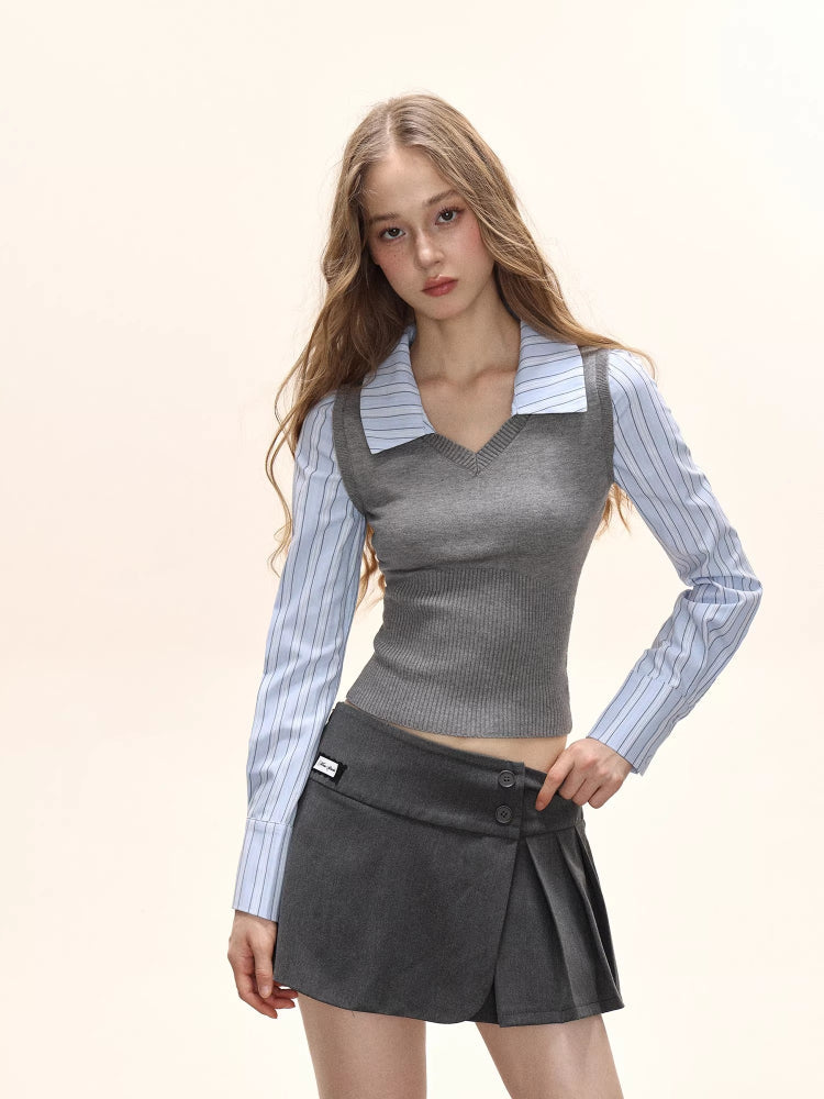 Close-up of a model's upper body showing the grey knit vest layered over a blue striped collared shirt.