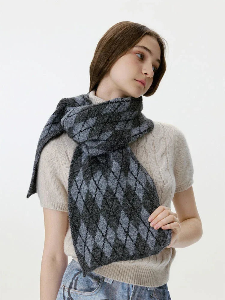 Woman adjusting a gray and black argyle knit scarf