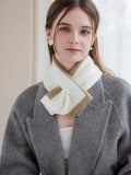 Model showcasing a two-tone knit scarf with a tan and white color block design