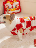 Corgi dog wearing a red and white checkerboard plush dog coat, side profile.