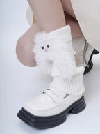 Detail of white fuzzy character leg warmers on a person's legs