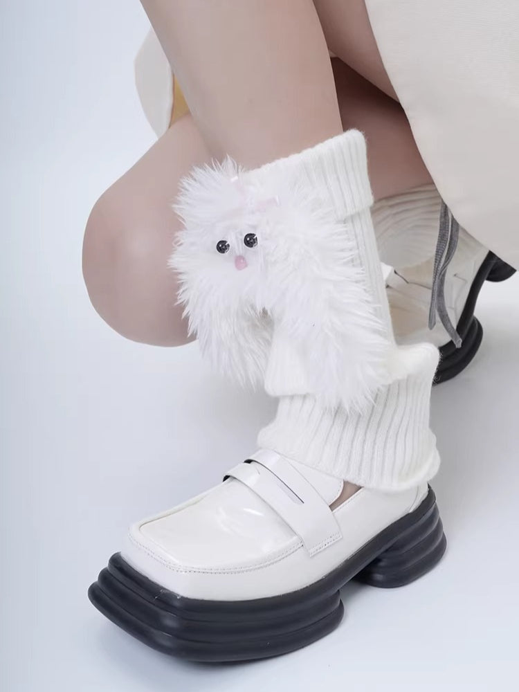 Detail of white fuzzy character leg warmers on a person's legs