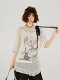 Model wearing a cream lace tunic with a graphic print and ruffled hem.