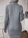 Woman wearing a grey cable knit turtleneck sweater dress with a belt