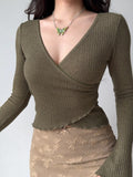 Front view of the green ribbed knit wrap top, showcasing the v-neckline and fitted silhouette.