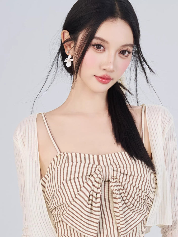 Close-up of the striped dress bodice with bow detail and the sheer overlay cardigan.