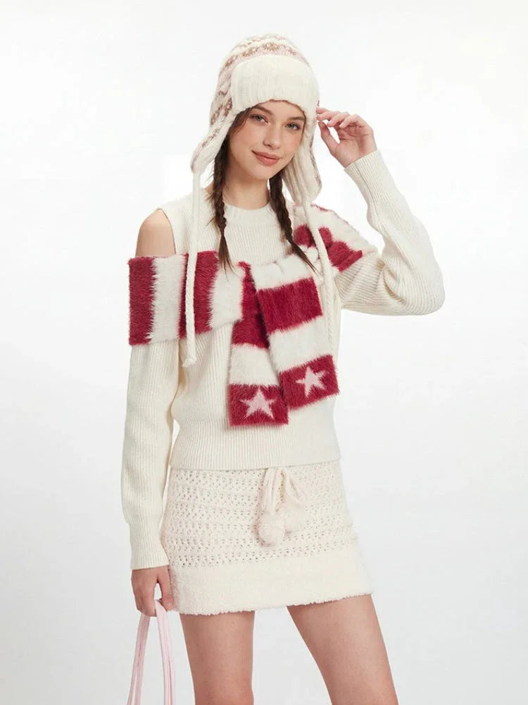 Detail shot of the cream knit mini skirt with a pom-pom drawstring.