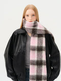 Close-up of a woman wearing a pink and brown plaid scarf