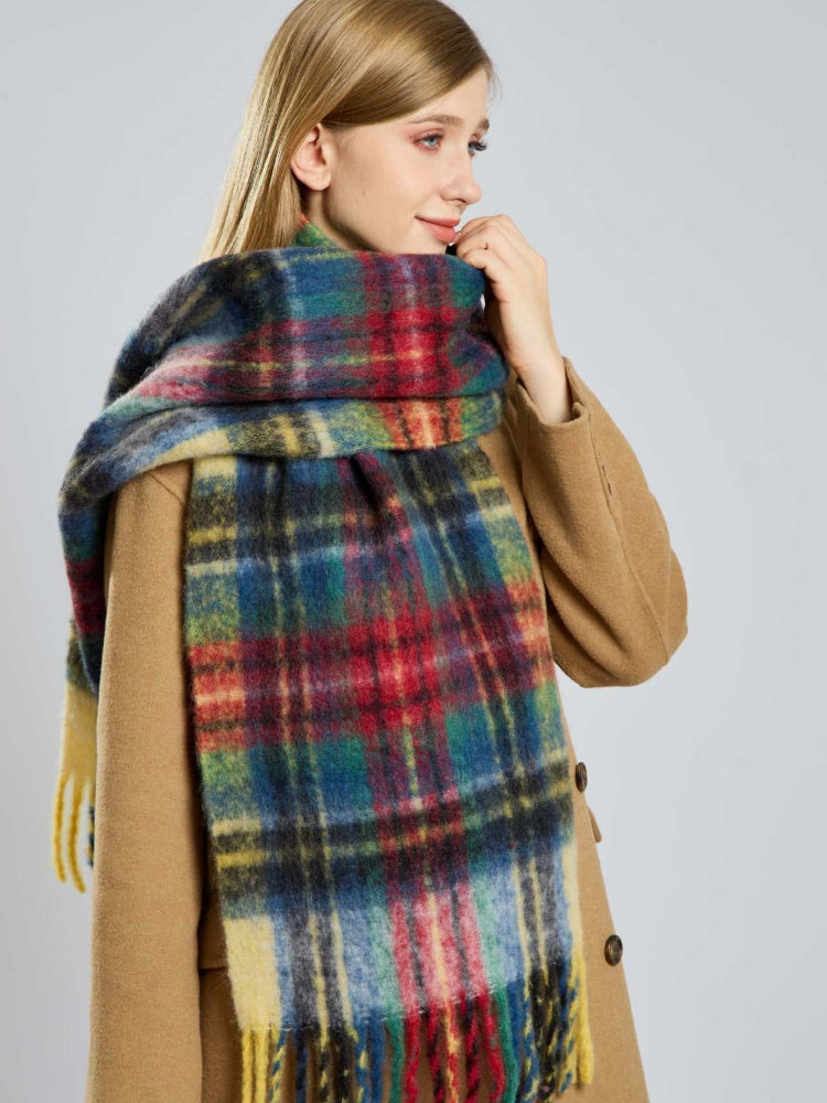 A woman models a cozy, oversized plaid scarf in multiple colors