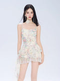 Woman wearing a floral print mini dress with spaghetti straps and ruffled hem