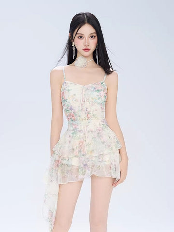 Woman wearing a floral print mini dress with spaghetti straps and ruffled hem