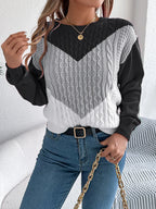 Model showcasing the fit of a women's long sleeve knit sweater.