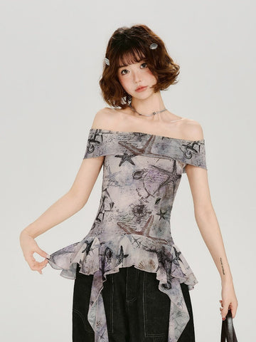 Woman wearing a grey off-the-shoulder top with a nautical print