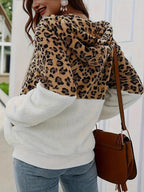 Woman wearing a leopard print and white fuzzy hooded jacket from the back