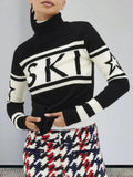 Close-up of a woman wearing a black and white knit turtleneck sweater with 'SKI' graphic