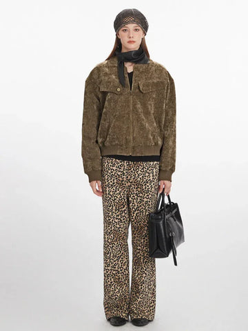 Woman wearing a brown crushed velvet bomber jacket with leopard print pants
