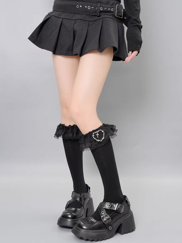 Black thigh-high socks with black lace trim and a heart-shaped charm with a cross detail.